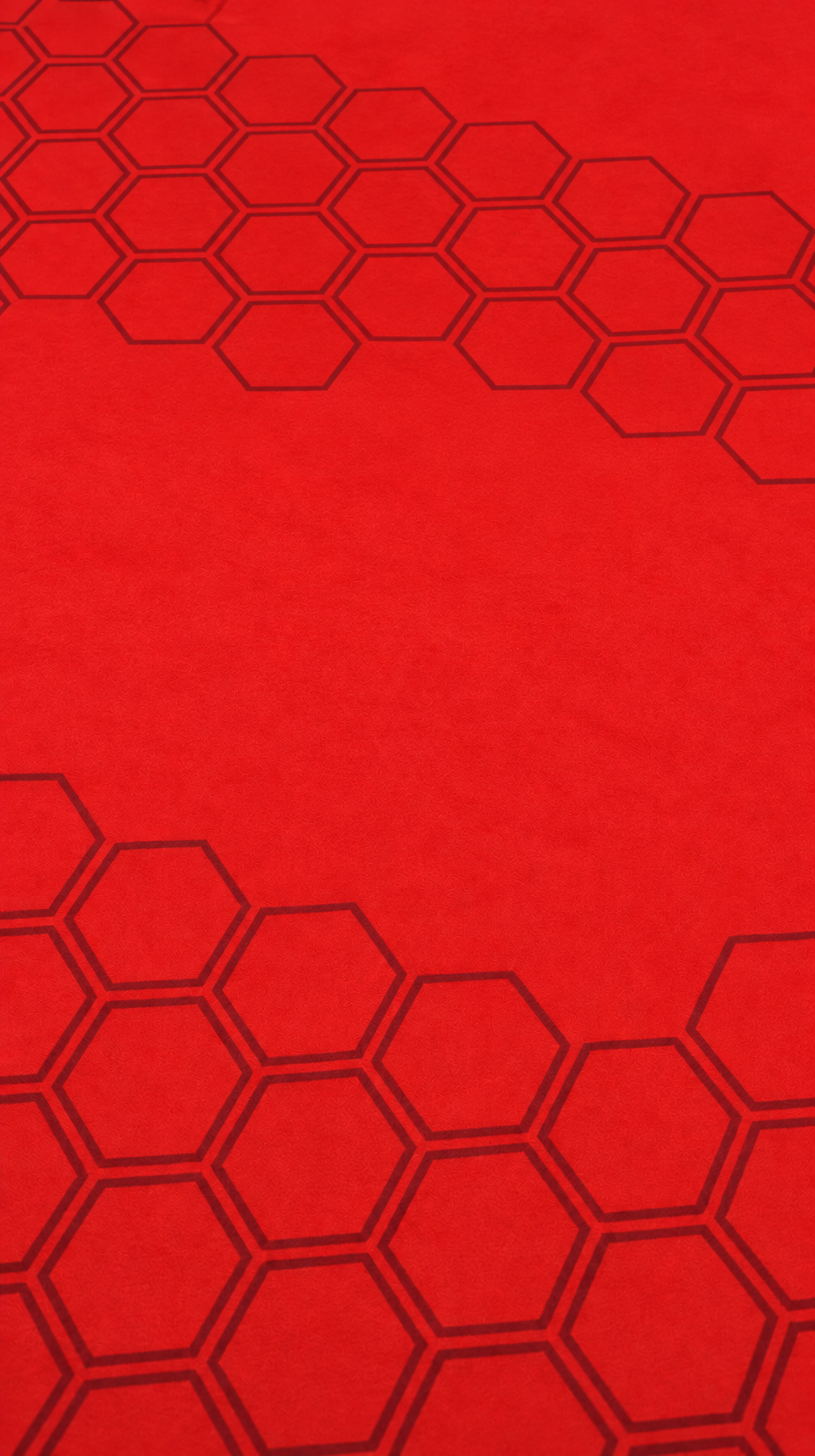 Clean red poker felt with a dark hexagonal pattern.