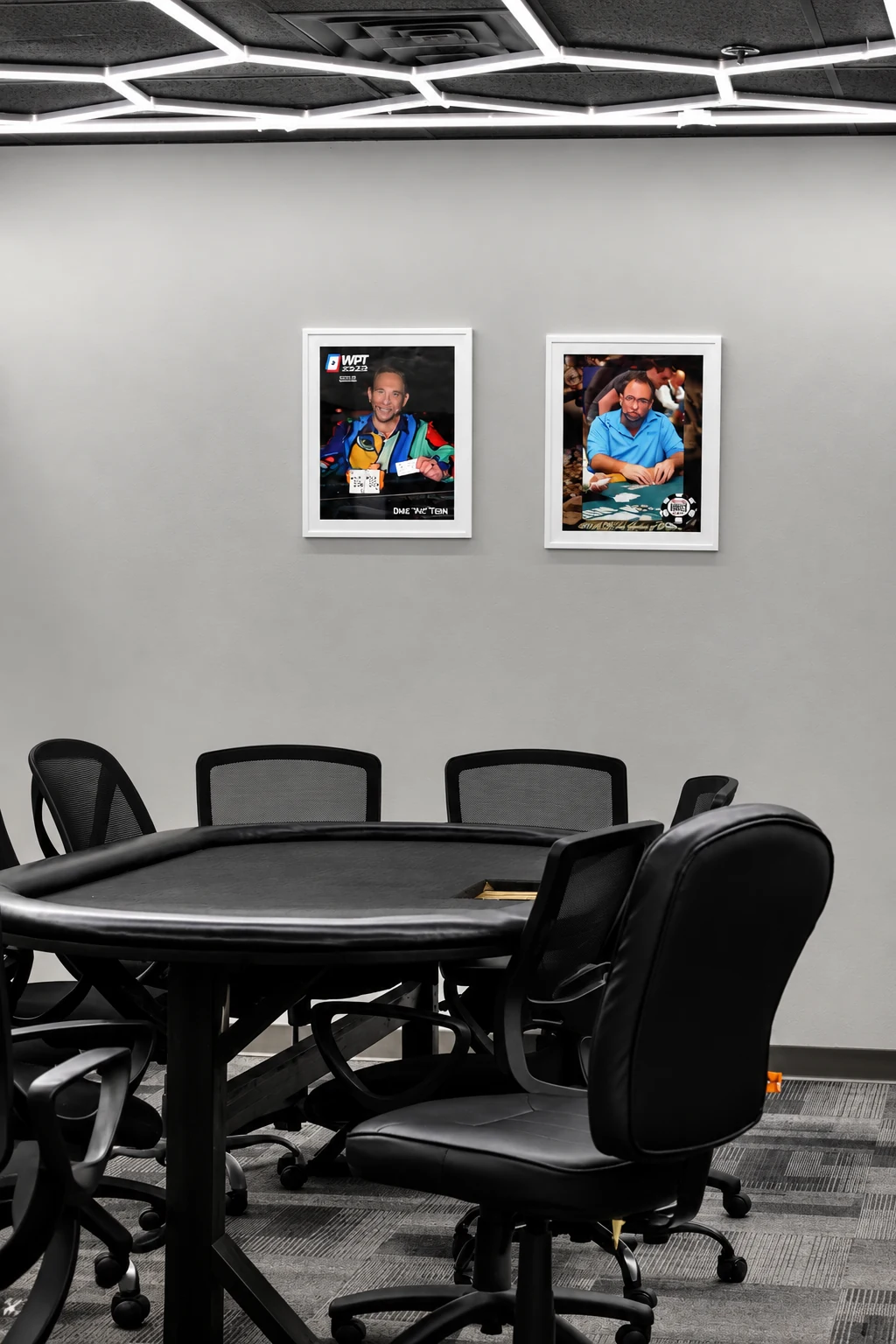 Empty Matador poker table beneath white hexagon ceiling lights.